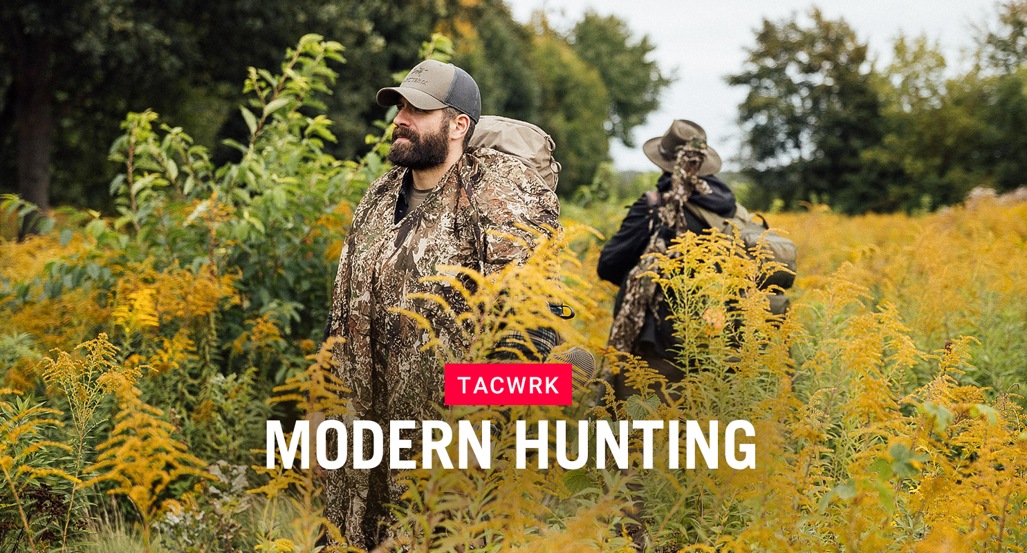 Zwei Jäger in moderner, taktischer Tarnkleidung von TACWRK durchqueren ein herbstliches Feld – Symbol für die Verbindung von Tradition, Natur und moderner Ausrüstung in der Modern Hunting Collection.